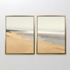 Tidal Meditation - Set of 2 features two framed paintings side by side, showcasing a calm beach with golden sand and gentle waves—ideal beach wall art for adding serene coastal decor to your space.