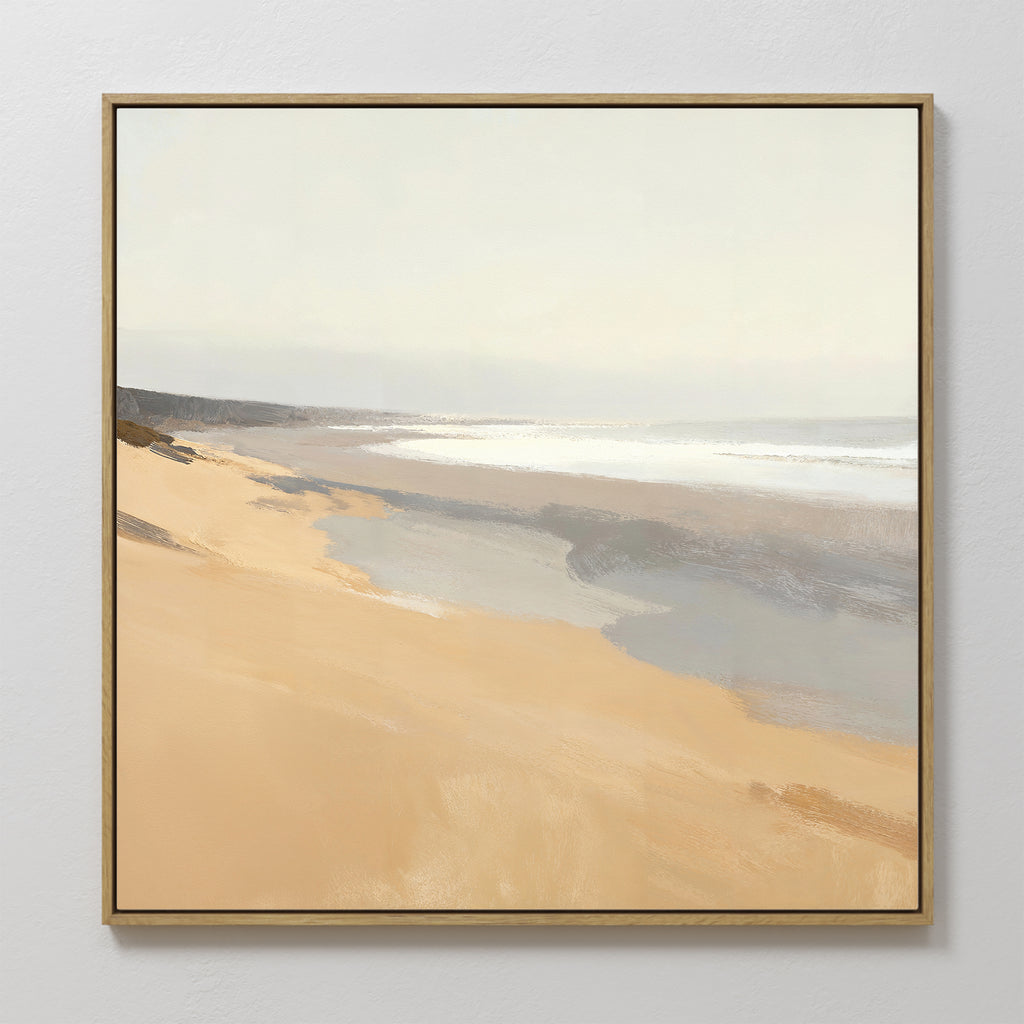 Tidal Meditation Canvas Art - Square: This framed canvas print captures a serene beach with soft golden sand, gentle waves, and a hazy sky in muted tones, bringing a peaceful, calming coastal vibe to your wall décor.