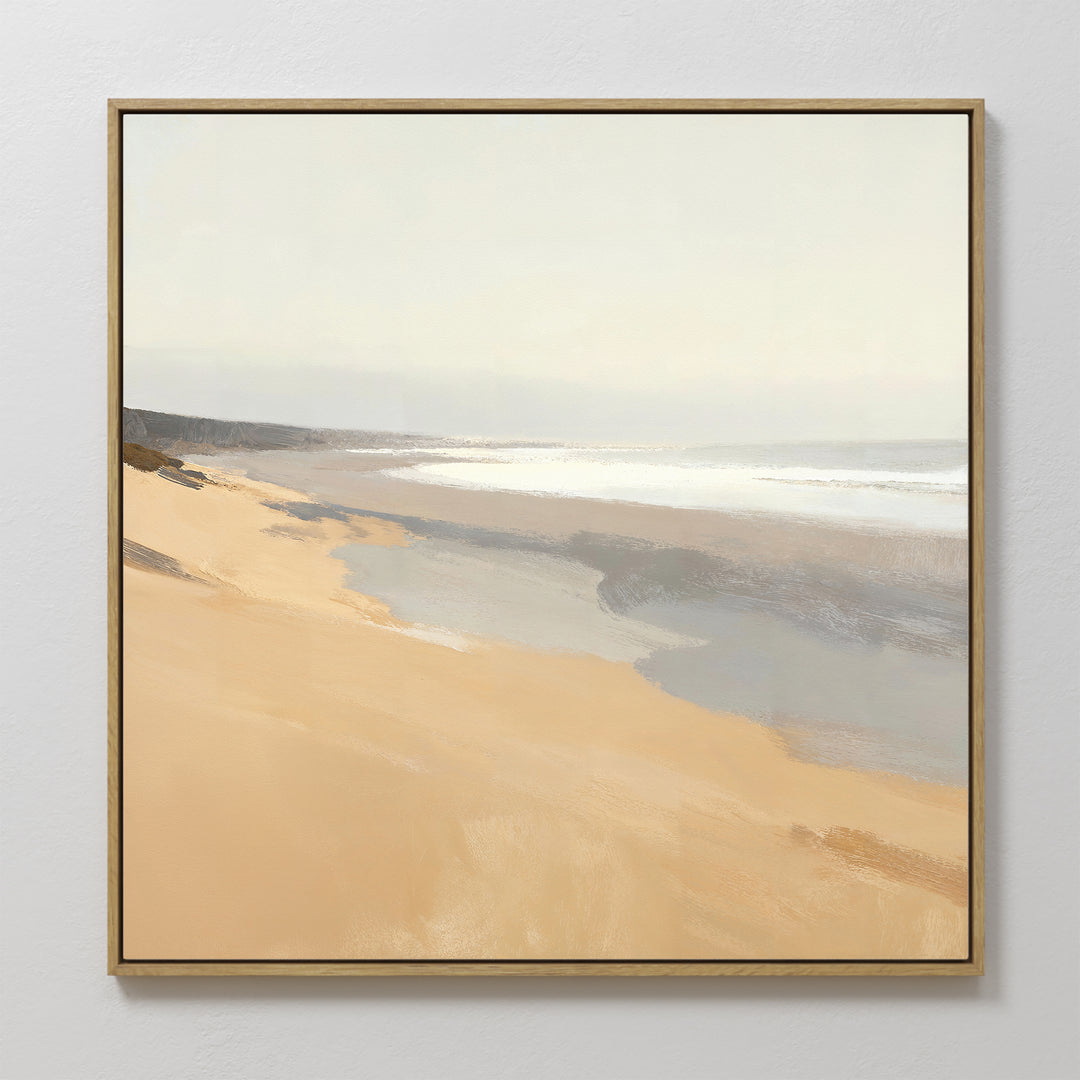 Tidal Meditation Canvas Art - Square: This framed canvas print captures a serene beach with soft golden sand, gentle waves, and a hazy sky in muted tones, bringing a peaceful, calming coastal vibe to your wall décor.