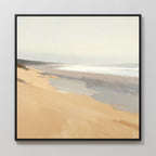 The Tidal Meditation Canvas Art - Square features a serene beach scene with soft beige sand, gentle waves, and a pale sky in muted colors. Displayed in a sleek black frame, it brings minimalist coastal tranquility to any light-toned wall.