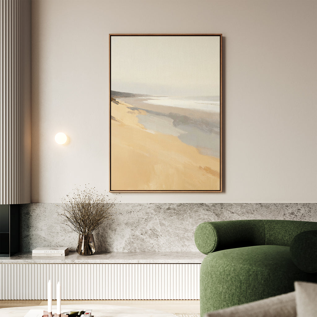 A modern living room with a green upholstered chair, marble-topped shelf, dried flowers in a vase, and "Tidal Meditation Canvas Art - Vertical"—a large framed abstract beach scene—hanging on a light-colored wall.