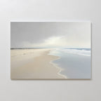 The Tidal Reflections Canvas Art - Horizontal depicts a calm, empty beach with gentle waves and footprints under a cloudy sky, making it perfect as calming wall decor for your white wall.