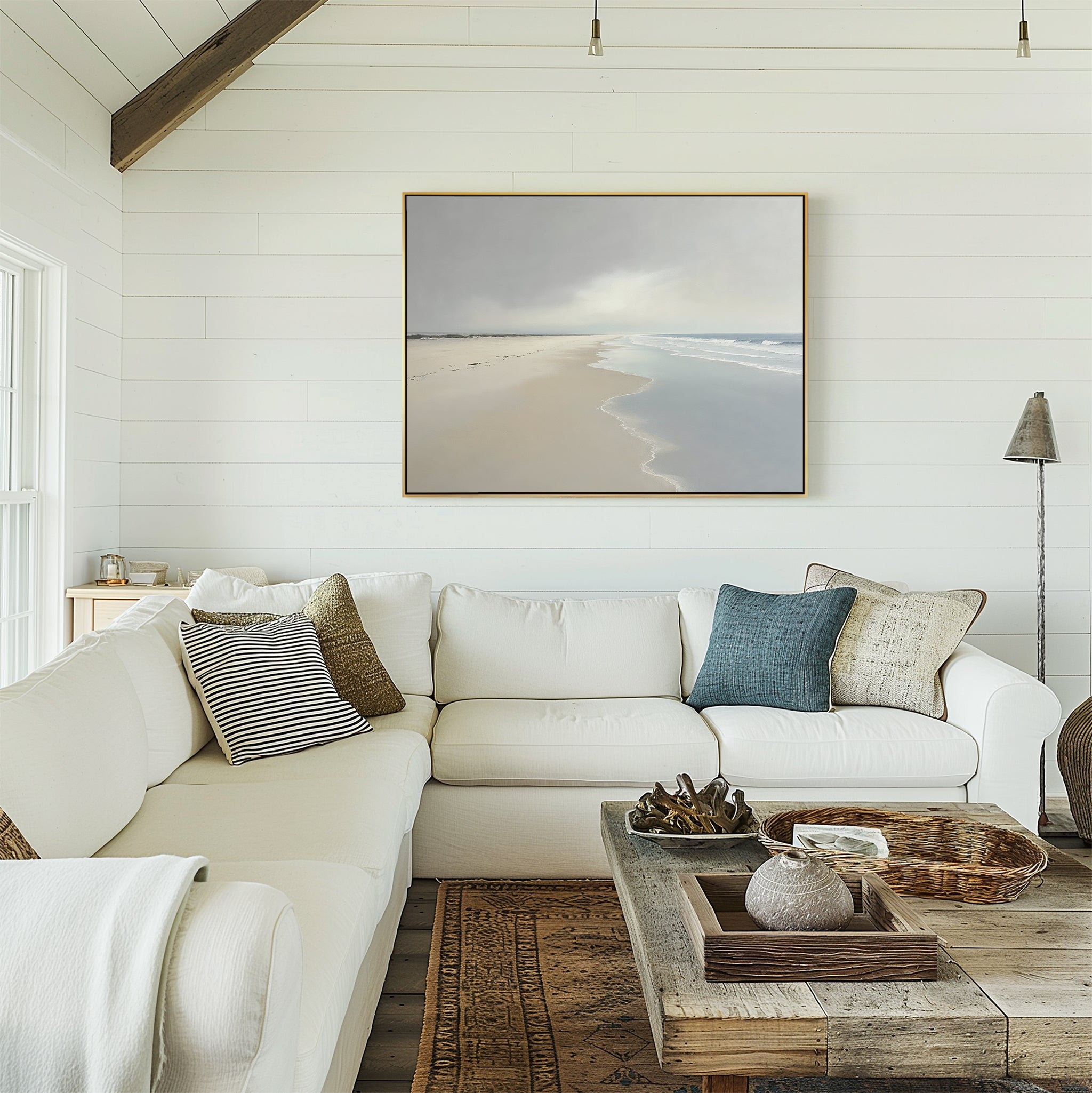 A living room with a large white couch and calming wall decor, featuring the Tidal Reflections Canvas Art - Horizontal on the wall.
