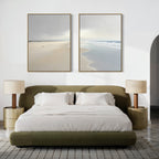 A modern bedroom with an olive green bed, white bedding, two beige nightstands with matching lamps, and calming Tidal Reflections - Set of 2 ocean art above the bed on a white wall.