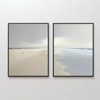 The "Tidal Reflections - Set of 2" features framed artworks depicting serene beach scenes with soft sand and gentle waves, creating a calm, minimalist coastal vibe—ideal for bringing soothing wall decor to any room.
