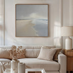 A neutral-toned living room with a beige sofa, cream pillows, dried flowers in a vase, a table lamp, and the Tidal Reflections Canvas Art - Square hanging above the sofa. Soft natural light fills the space.