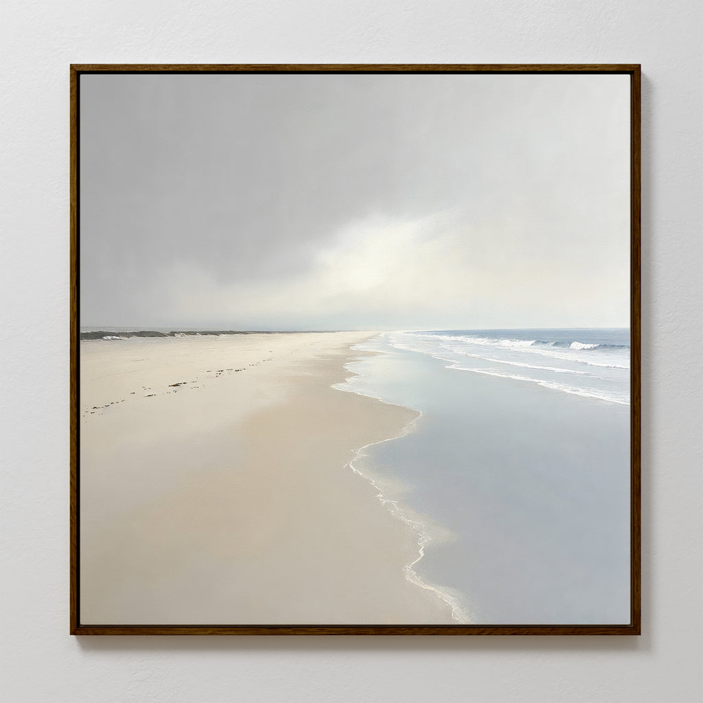 The Tidal Reflections Canvas Art - Square features a peaceful, empty beach with gentle waves and soft sand under a bright, cloudy sky—ideal as calming wall decor for any room.