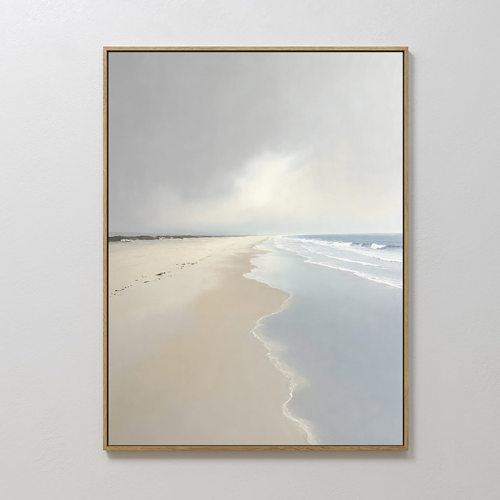 The Tidal Reflections Canvas Art - Vertical hangs on a plain white wall, depicting an empty beach with gentle waves, wet sand, and a cloudy sky in muted colors for a serene, tranquil touch.