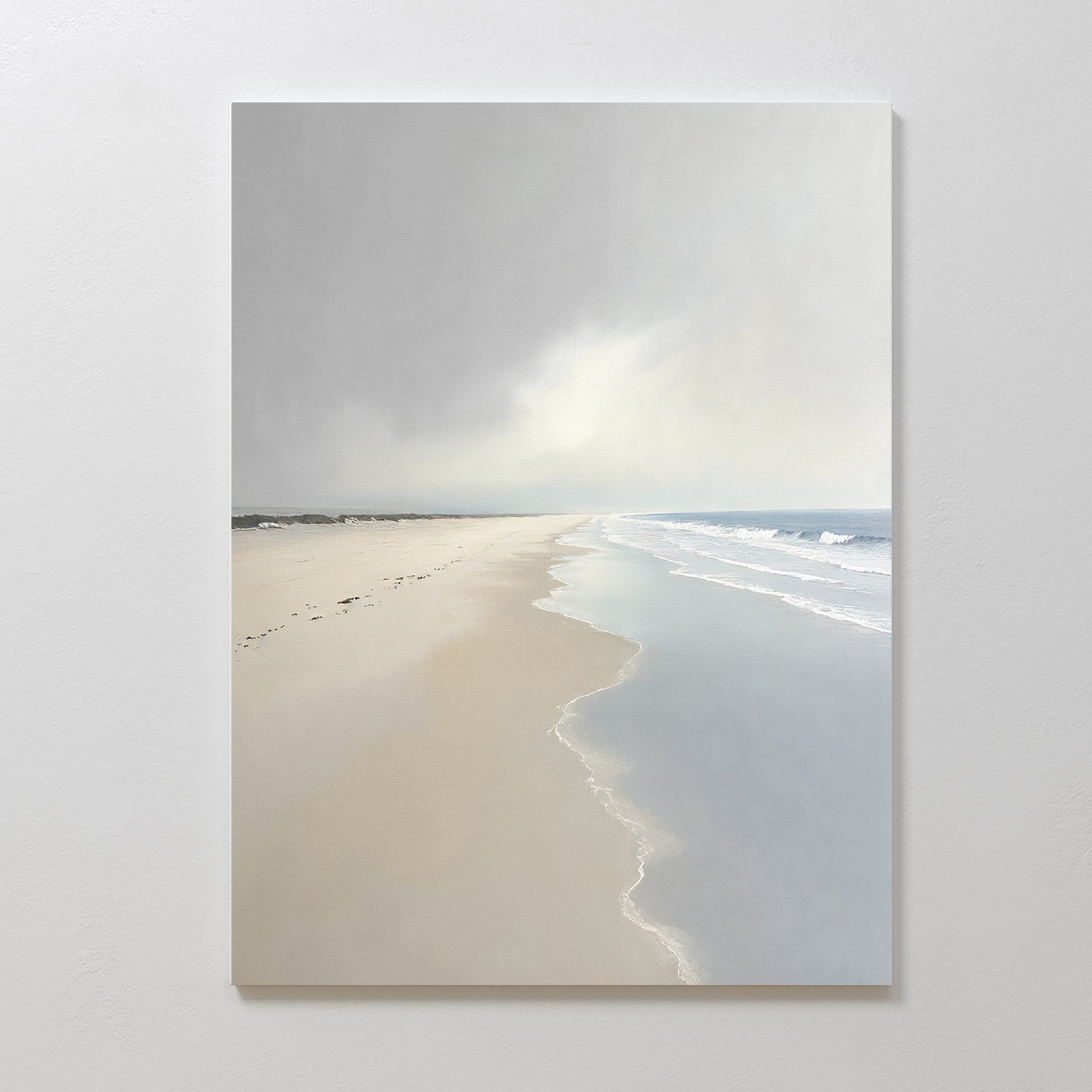 Tidal Reflections Canvas Art - Vertical features a calm, empty beach with gentle waves and a cloudy horizon, beautifully mounted on a white wall—perfect as calming wall decor.