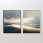 The Tidal Reverie - Set of 2 features framed canvas prints with calm coastal scenes in muted tones, cloudy skies, and gentle reflections, displayed side by side to bring Nordic Park serenity to any white wall.