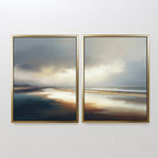 Tidal Reverie - Set of 2 features framed canvas prints showcasing a serene beach scene with reflective sand, tranquil water, and a cloudy sky. The horizon aligns across both pieces for seamless coastal wall art in soft, muted tones.