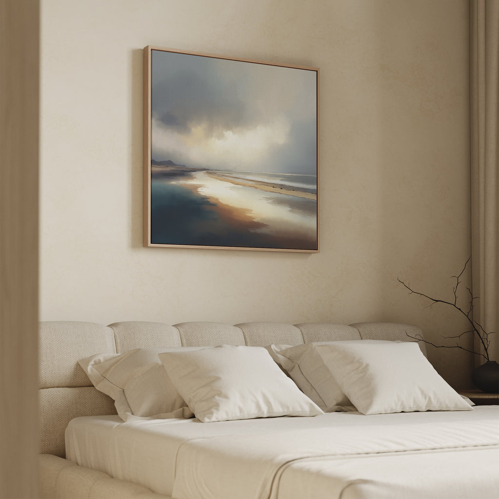 A minimal bedroom with a beige upholstered bed and white bedding is accented by the Tidal Reverie Canvas Art—a square wall print depicting a muted landscape—hung above. A bare branch in one corner adds to the serene atmosphere.