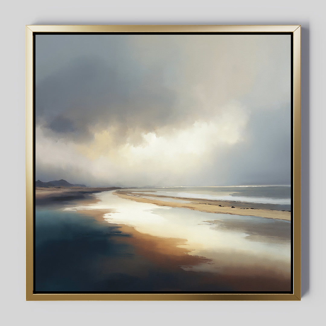 The Tidal Reverie Canvas Art - Square features a serene coastal scene with wet sand reflecting a cloudy sky, distant hills, and soft sunlight. Muted blues, browns, and whites make this framed canvas print perfect for tranquil spaces.
