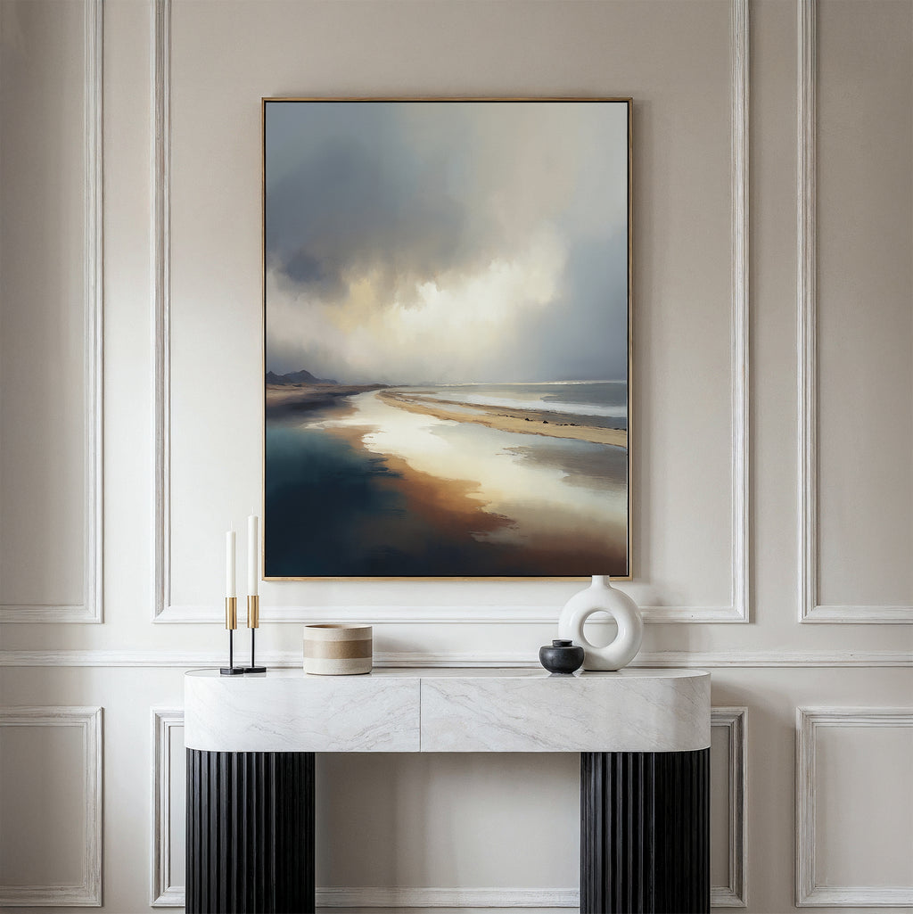 The Tidal Reverie Canvas Art - Vertical is displayed on a beige paneled wall above a marble-topped console table adorned with modern decor and candles, as soft natural light bathes the elegant space.