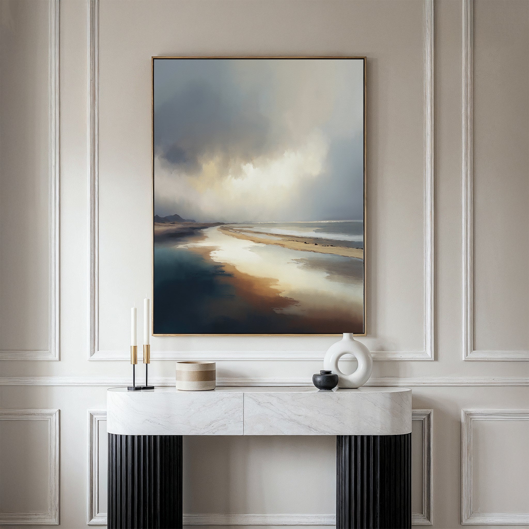 The Tidal Reverie Canvas Art - Vertical is displayed on a beige paneled wall above a marble-topped console table adorned with modern decor and candles, as soft natural light bathes the elegant space.