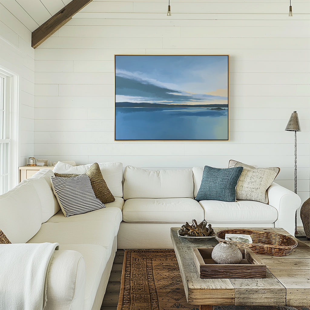 A bright living room with a white sectional, blue and neutral pillows, a wooden coffee table, and the Tranquil Reflections Canvas Art - Horizontal on a shiplap wall creates a serene, calming atmosphere.