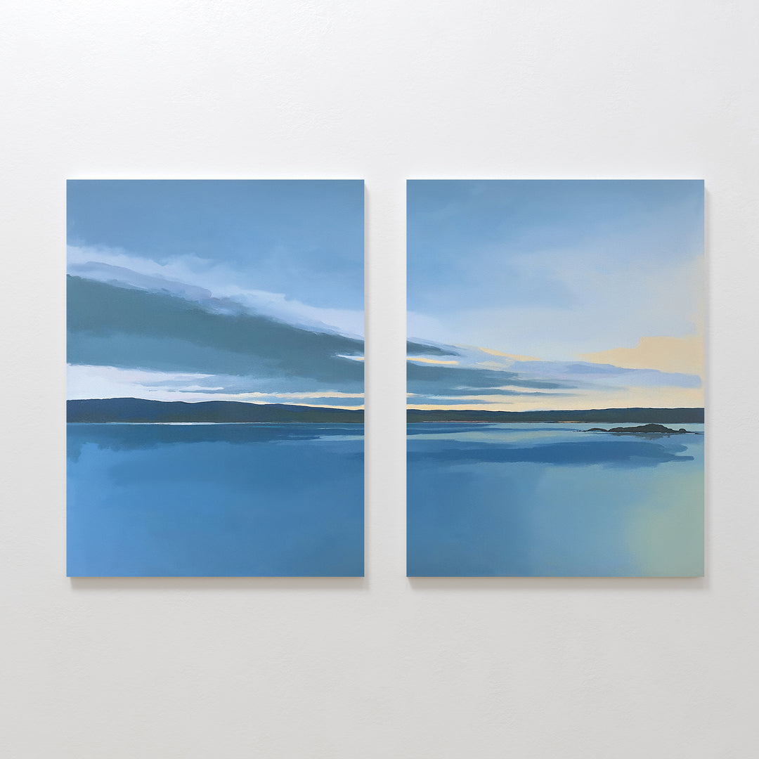 The Tranquil Reflections - Set of 2 features two calm blue seascapes with dark horizons and soft clouds fading to pale yellow, bringing serene Nordic Park-inspired beauty into your space as a tranquil canvas print.