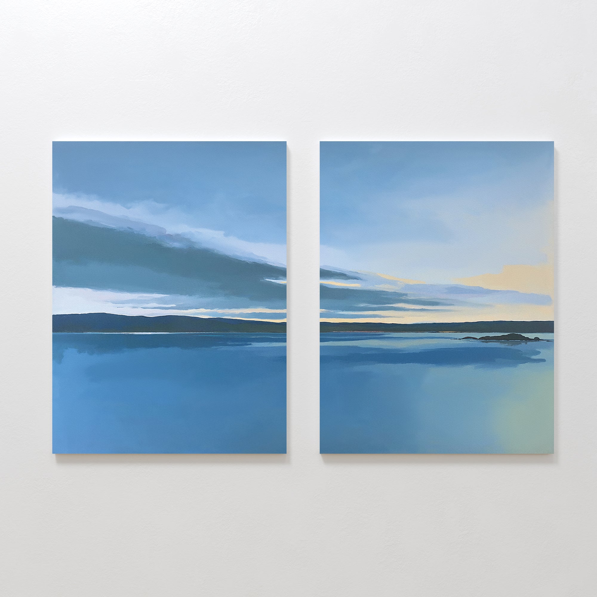 The Tranquil Reflections - Set of 2 features two calm blue seascapes with dark horizons and soft clouds fading to pale yellow, bringing serene Nordic Park-inspired beauty into your space as a tranquil canvas print.
