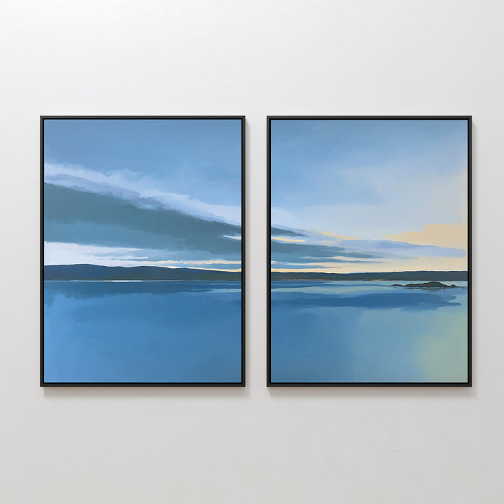 The "Tranquil Reflections - Set of 2" features two framed prints depicting serene blue seascapes with dark horizons, soft clouds, and touches of yellow sky, perfectly capturing a peaceful coastal scene for your space.
