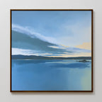 Tranquil Reflections Canvas Art - Square: a framed serene wall art featuring a calm lake under a blue sky with clouds, distant hills, and gentle yellow horizon light—ideal for peaceful bedroom decor.