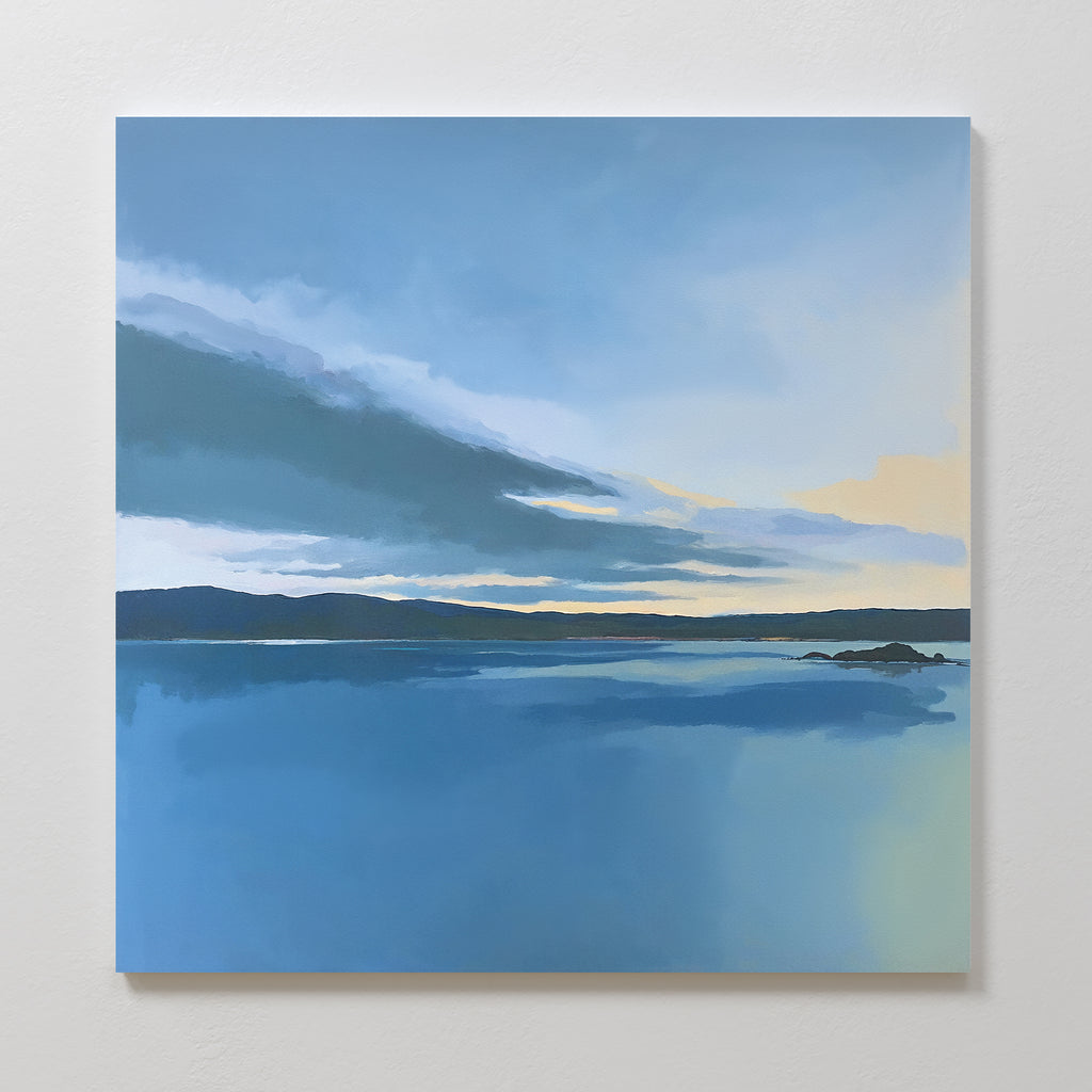 The "Tranquil Reflections Canvas Art - Square" features a calm sea, distant hills, and a cloudy blue sky with yellow sunrise or sunset accents—ideal serene wall art to enhance tranquil bedroom decor.