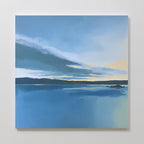 The "Tranquil Reflections Canvas Art - Square" features a calm sea, distant hills, and a cloudy blue sky with yellow sunrise or sunset accents—ideal serene wall art to enhance tranquil bedroom decor.