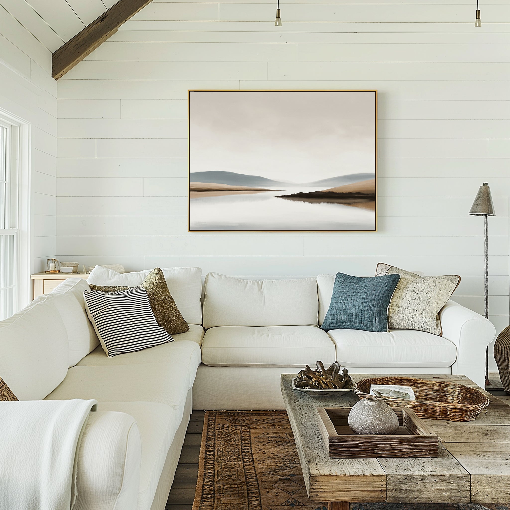 A cozy living room with white shiplap walls, an L-shaped white sofa with cushions, a rustic wooden coffee table, and the Tranquil Waters Canvas Art - Horizontal displayed above the couch.