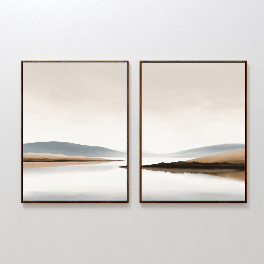 The Tranquil Waters - Set of 2 features minimalist lakeside landscape canvas prints, each with calm water and soft hills in beige, blue, and gray tones. Both framed pieces create a serene wall art display on a white wall.