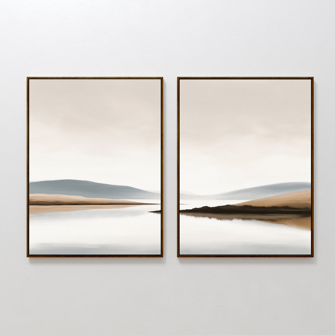 The Tranquil Waters - Set of 2 features minimalist lakeside landscape canvas prints, each with calm water and soft hills in beige, blue, and gray tones. Both framed pieces create a serene wall art display on a white wall.