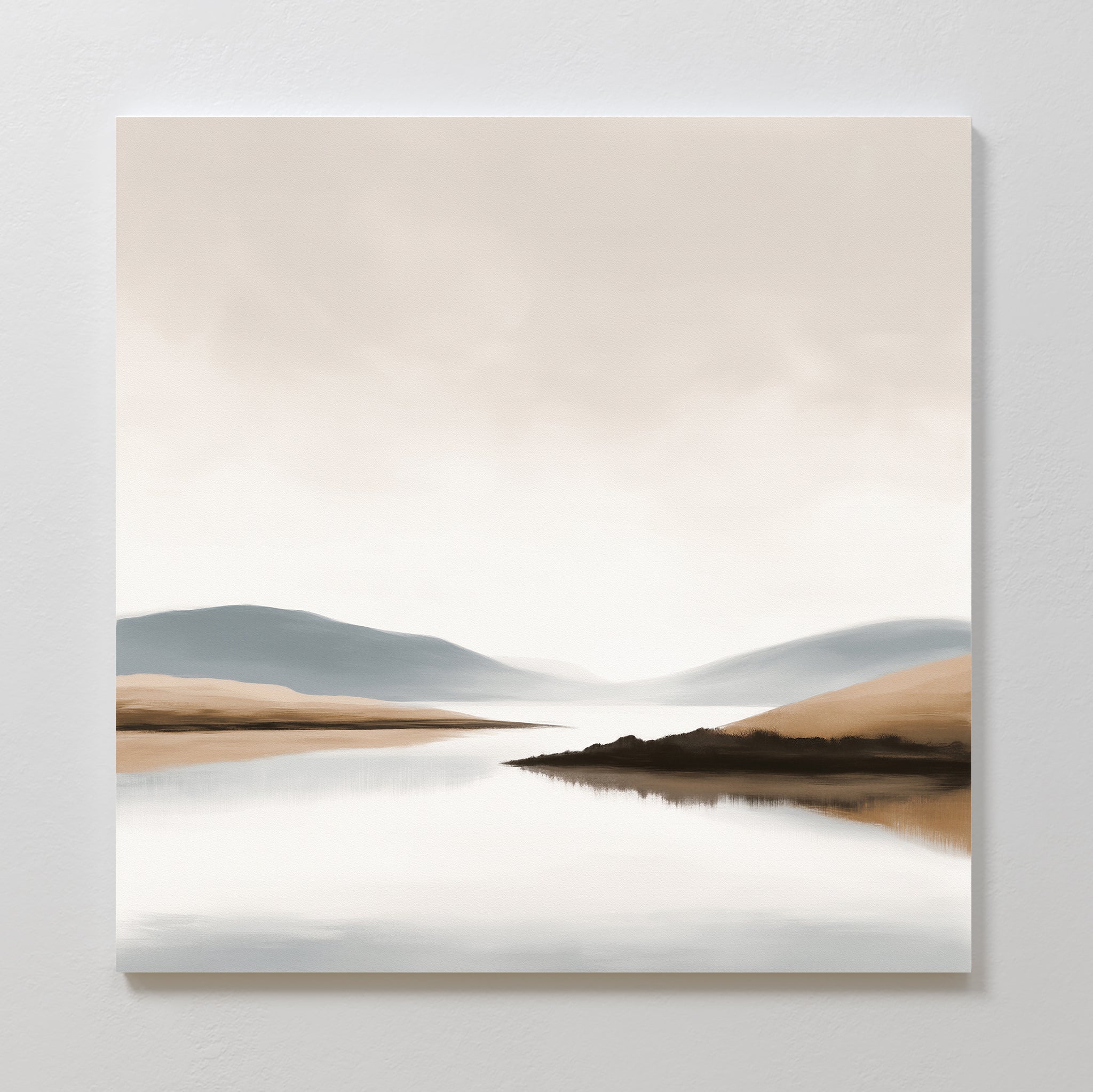 Tranquil Waters Canvas Art - Square features a minimalist lakeside landscape with calm water reflecting soft beige and gray hills beneath a cloudy sky, creating serene, muted decor perfect for modern living rooms.