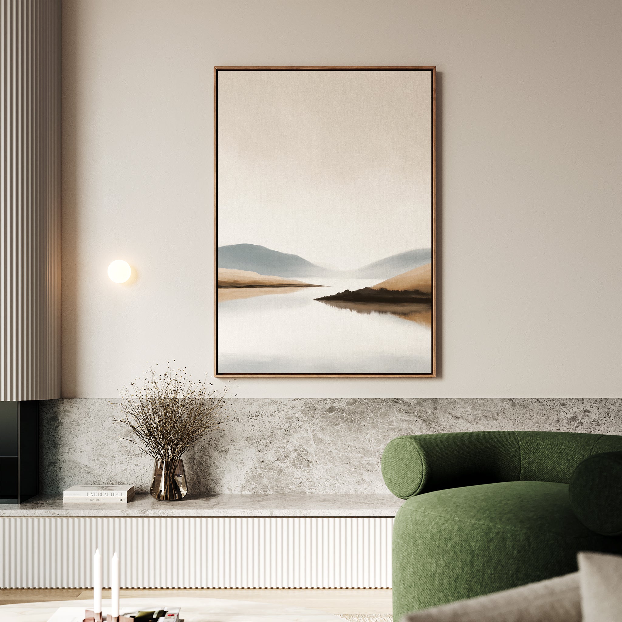A modern living room with a green armchair, marble shelf with dried flowers, and the Tranquil Waters Canvas Art - Vertical featuring misty mountains and serene waters hanging above the calm space.