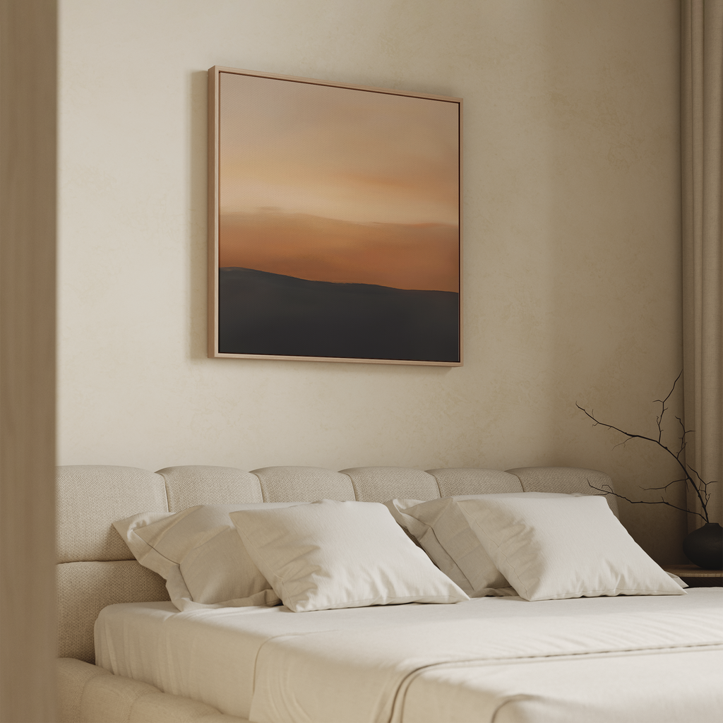 A minimalist bedroom with a beige upholstered bed, white pillows, and light bedding. Above the bed is the Tranquil Vista Abstract Canvas Art, featuring warm orange and dark tones. A simple vase with bare branches sits on the bedside table.