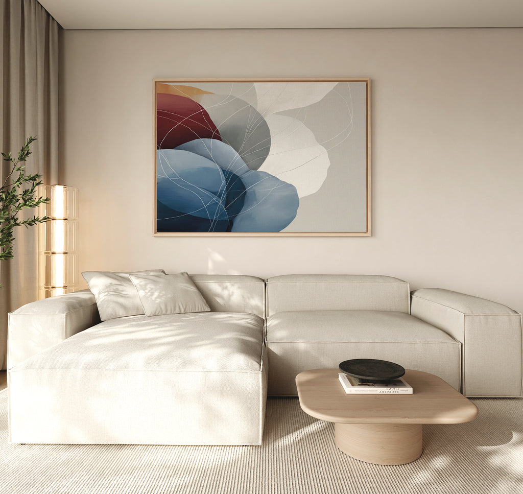 A modern living room with a light beige sectional, low wooden coffee table, tall plant, and the Translucent Petals Canvas Art - Horizontal creates an inviting Nordic Park-inspired vibe.
