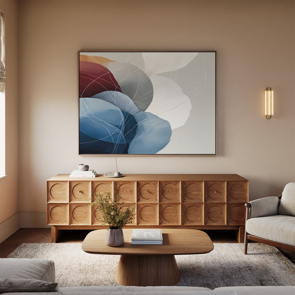 A cozy living room with a light wood cabinet, the Translucent Petals Canvas Art - Horizontal above it, a beige sofa, wooden coffee table with a vase of flowers, and soft natural lighting in a minimalist modern décor.