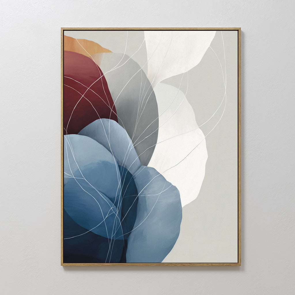 Translucent Petals Canvas Art - Vertical showcases overlapping organic shapes in blue, burgundy, and white, accented with thin white lines. This contemporary framed piece is displayed against a light-colored wall.