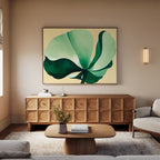 A modern living room with light walls, the Tropical Serenity Canvas Art - Horizontal above a wooden sideboard, a round wooden coffee table, a white sofa, fresh flowers in a vase, and a wall sconce creates an inviting and relaxed atmosphere.