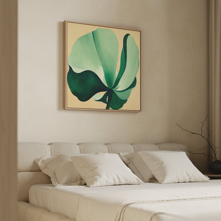 A minimal bedroom features a beige bed, white pillows, and the Tropical Serenity Canvas Art - Square above the headboard. Soft natural light from a window with right-side curtains enhances the serene coastal wall decor.