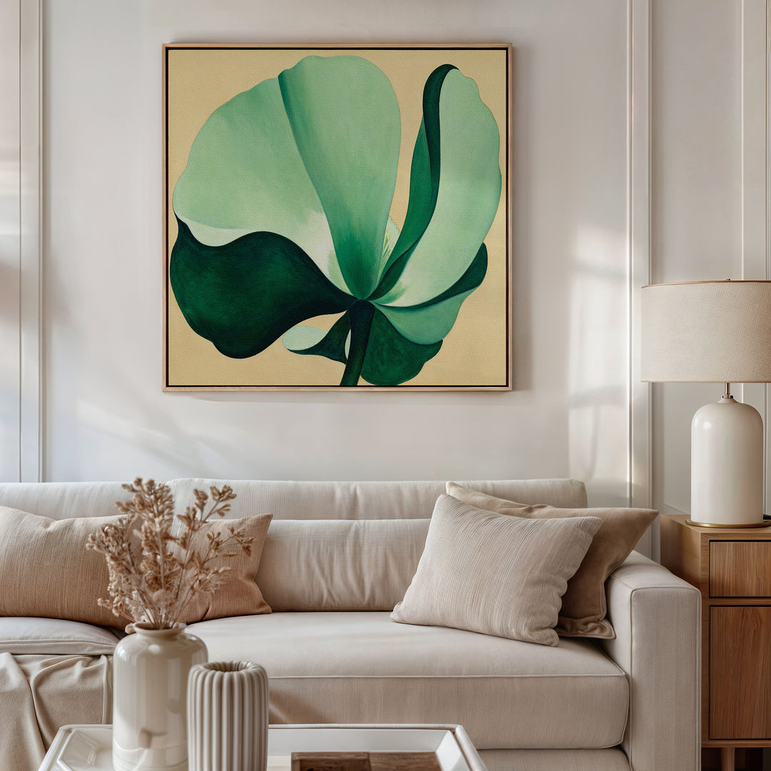 A modern living room features a beige sofa with neutral cushions, a side table with a lamp, and the Tropical Serenity Canvas Art - Square above the couch. Dried flowers in a vase rest on the coffee table, completing the coastal decor.