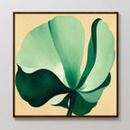 The Tropical Serenity Canvas Art - Square showcases a large, abstract green flower with broad petals on a pale beige background, bringing calming depth and style to any space.