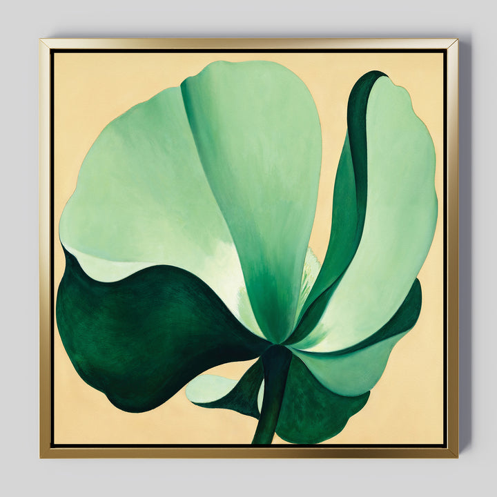 Tropical Serenity Canvas Art - Square features a large, abstract green flower with broad petals on soft beige canvas in a gold and black-edged frame—an elegant choice for coastal wall decor.