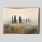 The Tuscan Veil Canvas Art - Horizontal features a rustic house amid cypress trees and fog, rendered in muted earthy tones with a soft impressionistic style—perfect for adding classic Tuscan vibes to any plain gray wall.