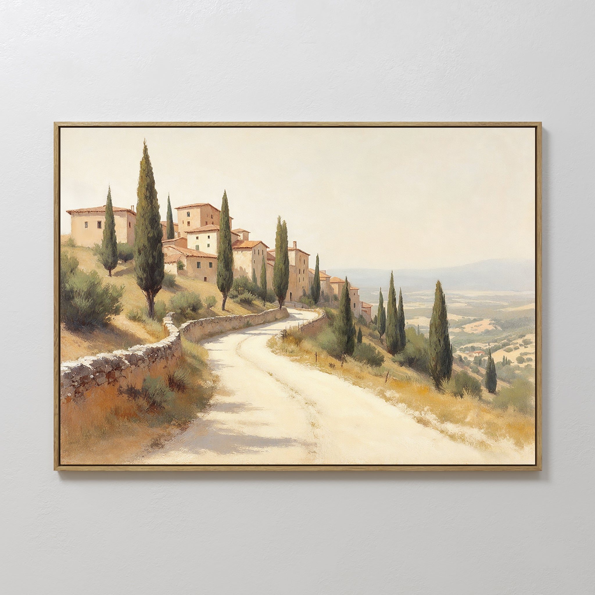 The Tuscan Village Canvas Art - Horizontal features a sunlit Mediterranean scene with cypress-lined winding roads, tan buildings with red roofs, and rolling hills—perfect rustic wall art for any space.