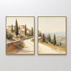 The "Tuscan Village - Set of 2" features canvas prints of a winding road through stone buildings and cypress trees under a hazy sky, creating connected scenes for charming rustic Mediterranean wall art.