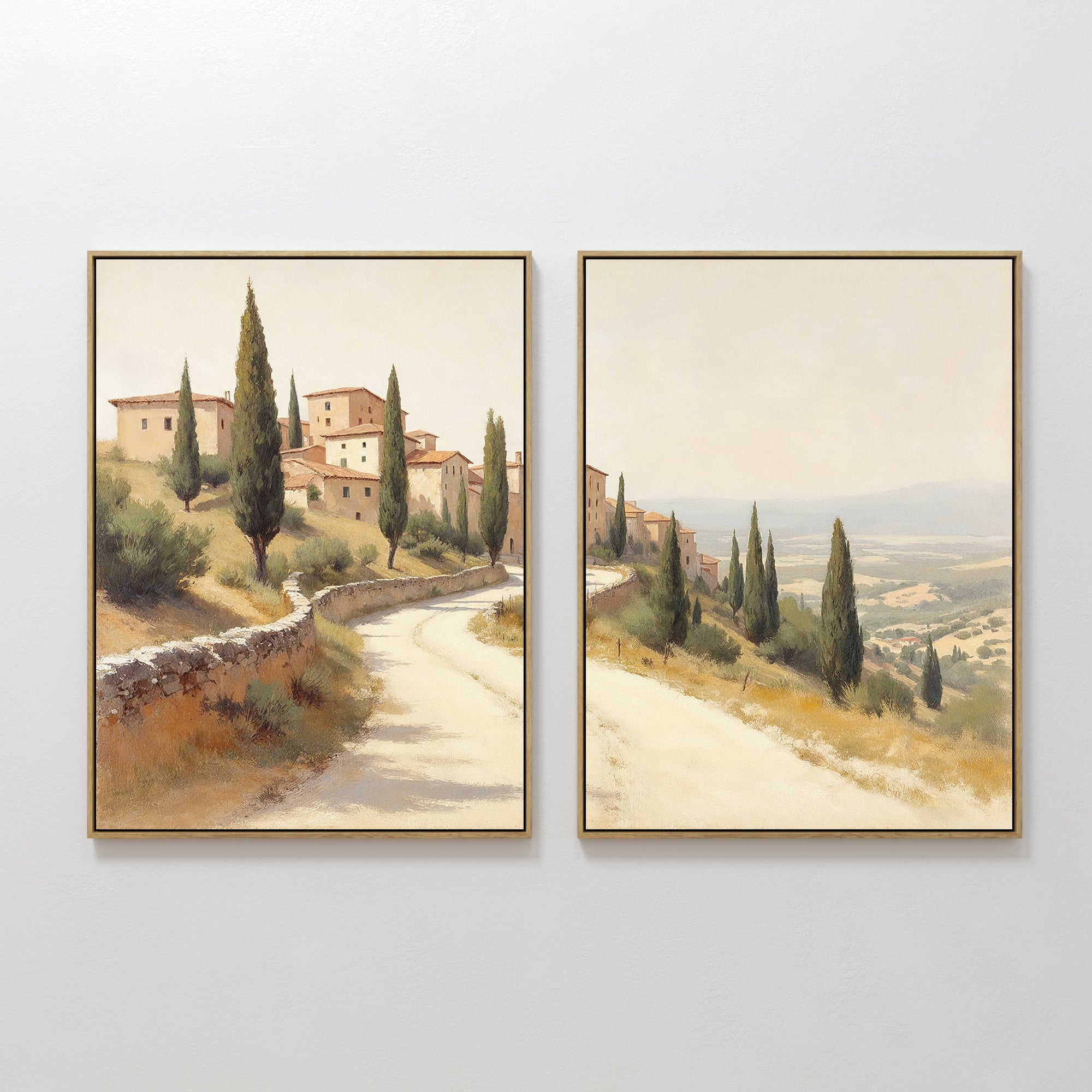 The "Tuscan Village - Set of 2" features canvas prints of a winding road through stone buildings and cypress trees under a hazy sky, creating connected scenes for charming rustic Mediterranean wall art.