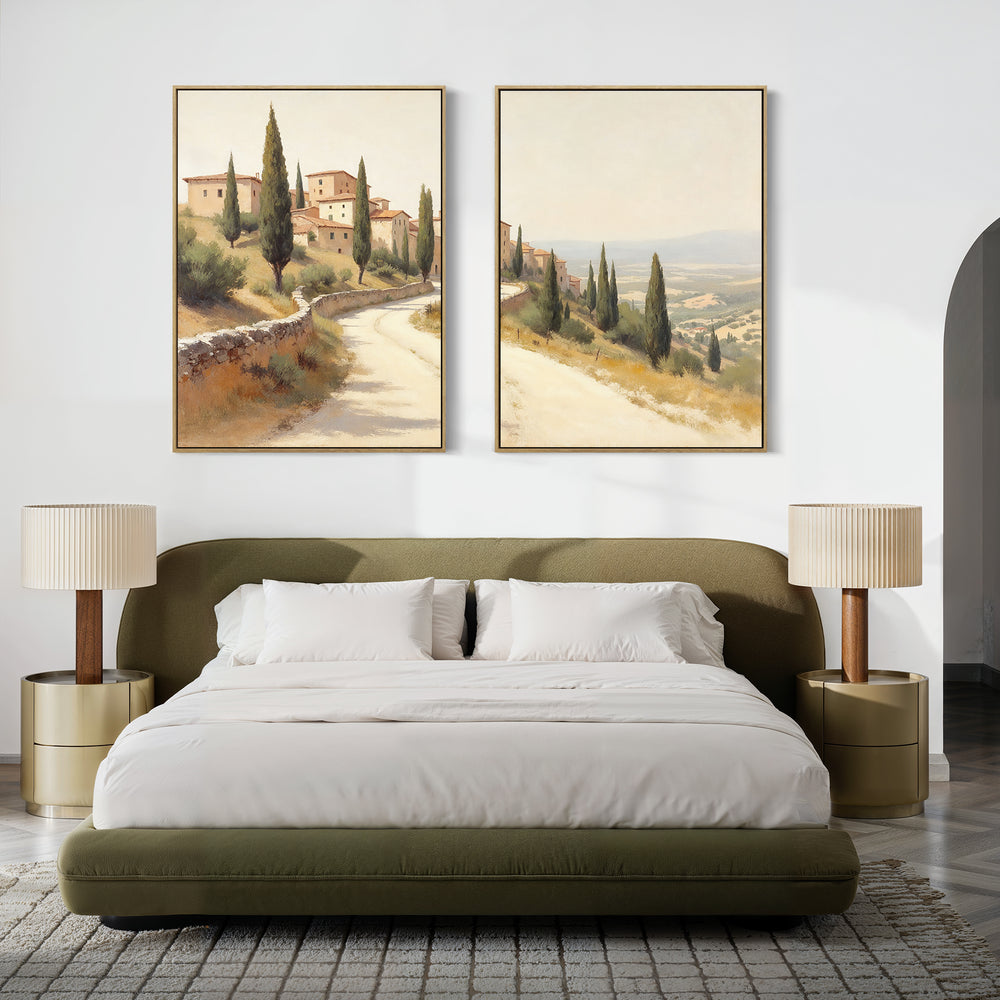A modern bedroom with a green upholstered bed, white bedding, matching side tables with pleated lamps, and the Tuscan Village - Set of 2 canvas prints with Mediterranean scenery hanging above the bed.