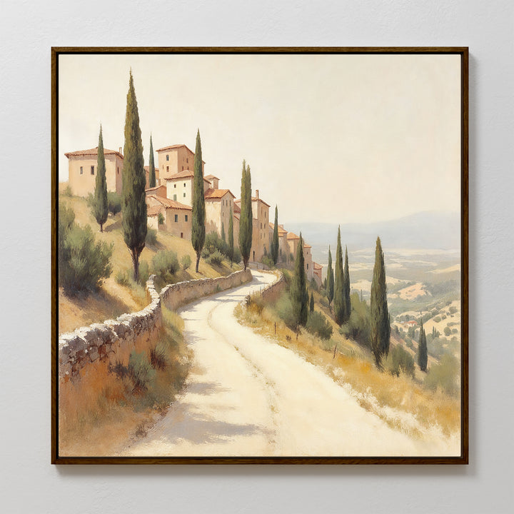 Tuscan Village Canvas Art - Square: Framed Mediterranean print features a winding cypress-lined road leading to rustic hillside buildings under a hazy sky, capturing the serene charm of a Tuscan countryside landscape.