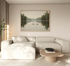 A modern living room with a light beige sectional sofa, a wooden coffee table, and the Twin Swans Serenity Canvas Art - Horizontal: a large framed artwork of two swans on a calm lake with trees, hanging on the wall.