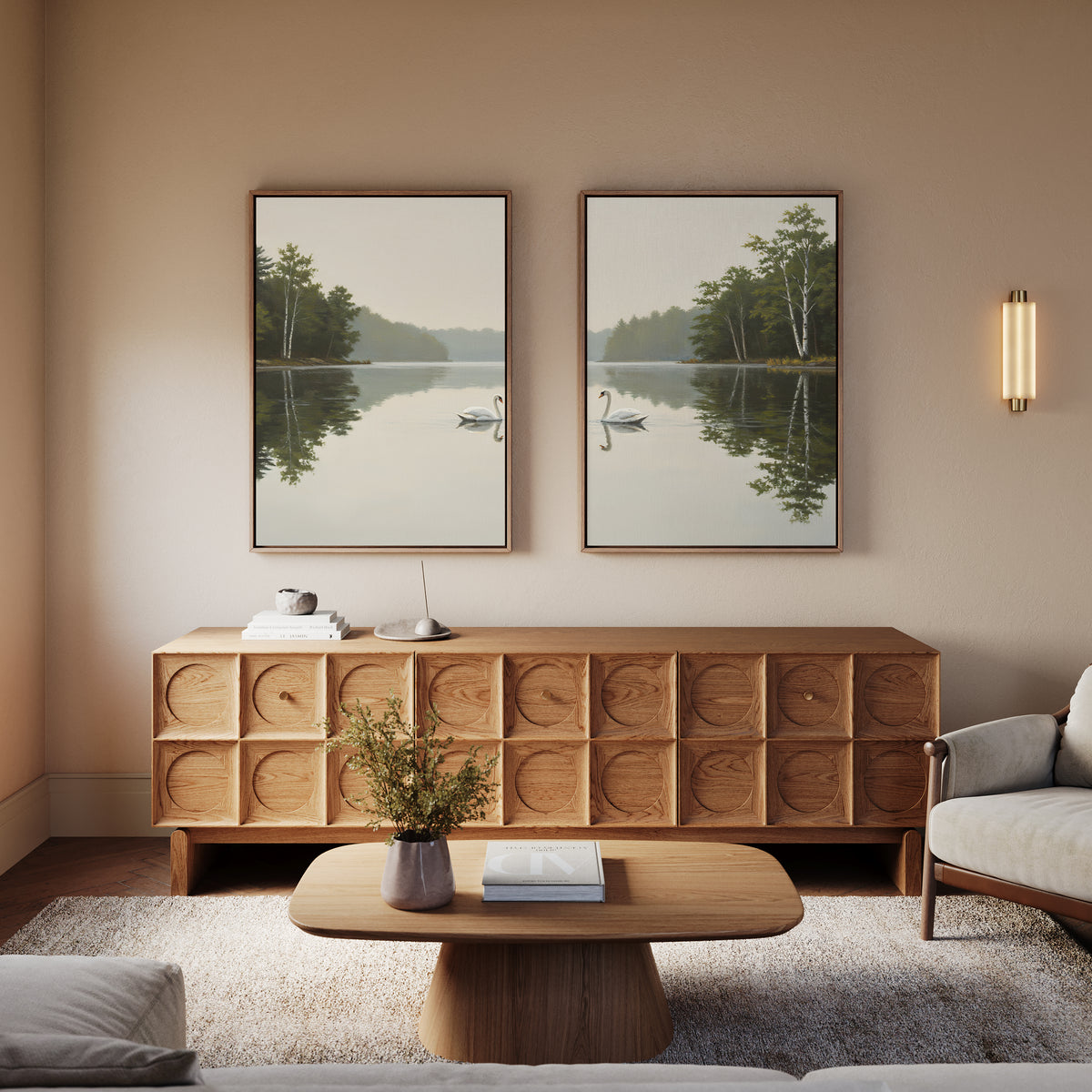 A modern living room with wooden furniture, a low coffee table, textured sideboard, neutral-toned sofa, and the "Twin Swans Serenity - Set Of 2" wall art above the sideboard. Soft lighting enhances the cozy Nordic decor.