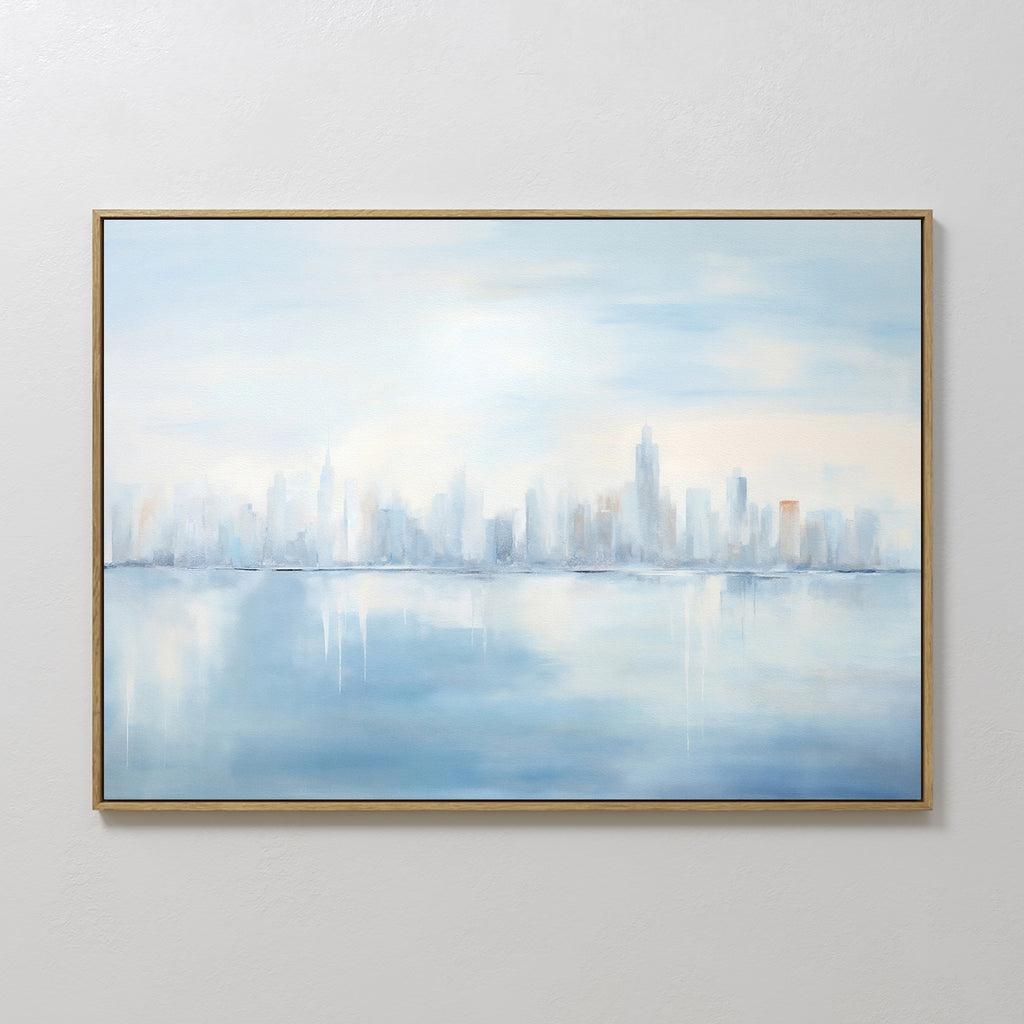 The Urban Mirage Canvas Art - Horizontal features a dreamy, abstract city skyline reflected on water in soft blue, white, and gray tones—perfect wall art for modern living room decor.