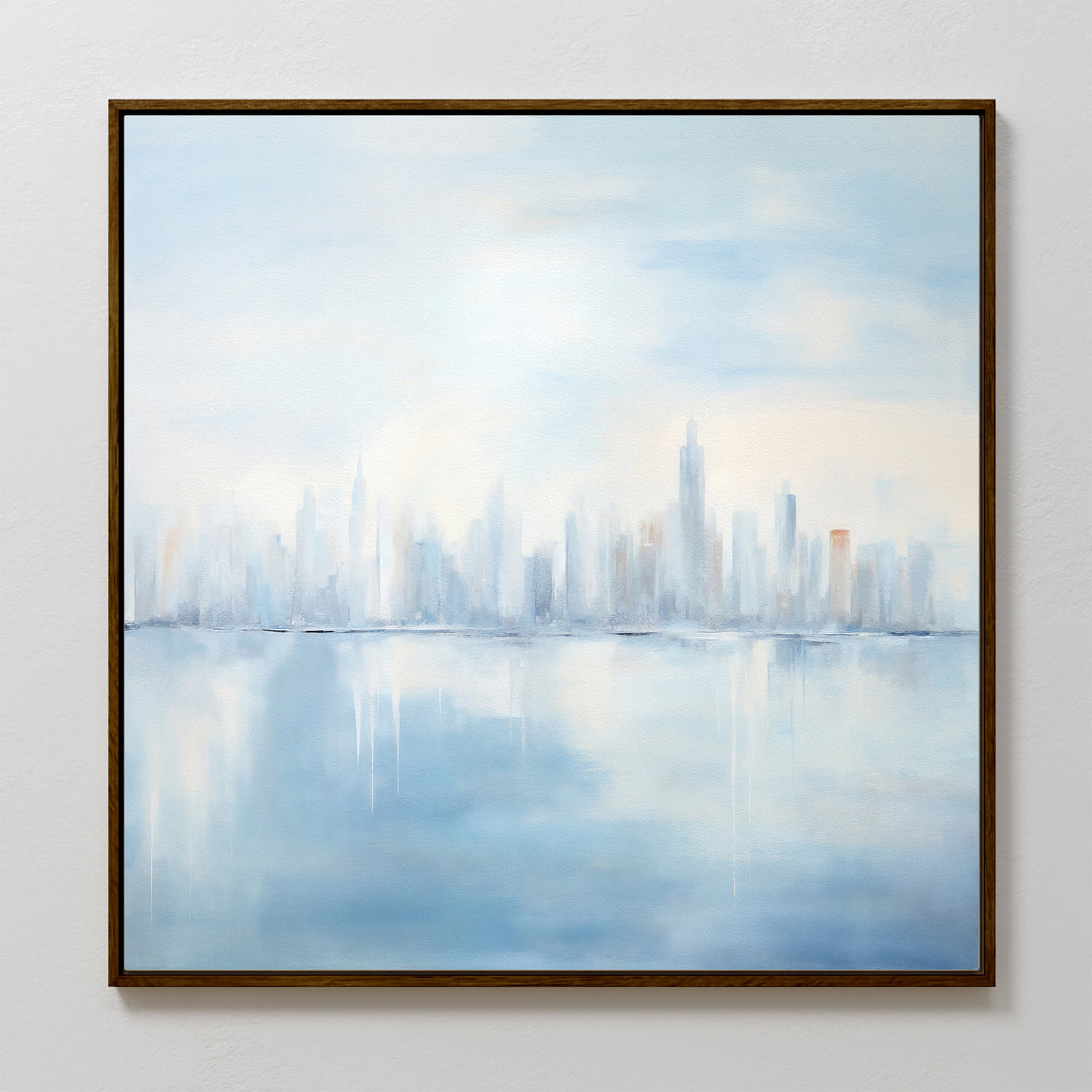 Urban Mirage Canvas Art - Square: A dreamy city skyline in soft blue and white, with tall buildings reflected on calm water. Perfect modern wall decor for a serene, blurred ambiance in your living room. Framed and ready to hang.